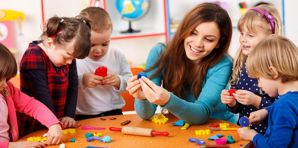 Nursery teacher playing with the kids.